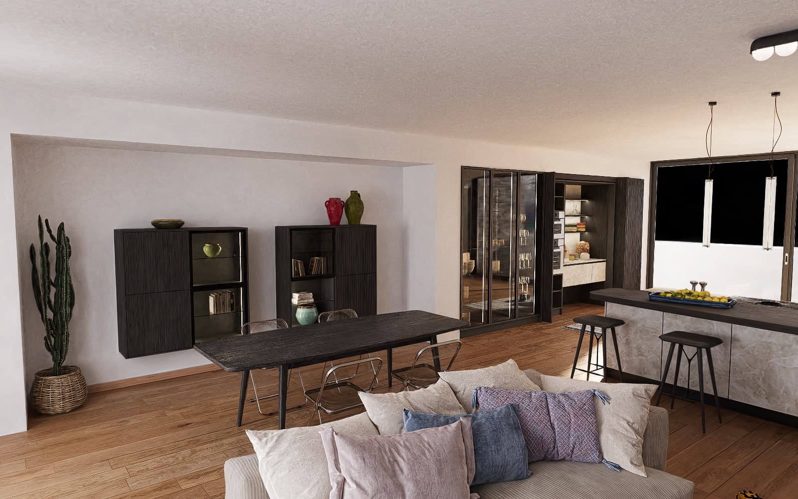 Open-plan living and dining space with a dark timber table, built-in shelving and a kitchen island beyond, lit by daylight from a full-height window.